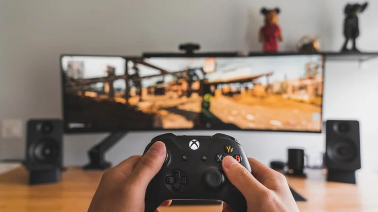 Person holding a black game controller