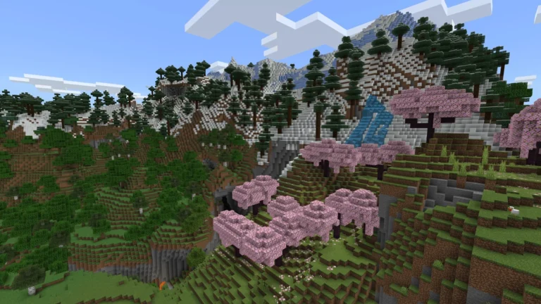 A snow-topped mountainside in Minecraft covered in trees across multiple biomes