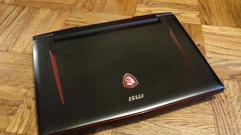 MSI gaming laptop resting on a wood floor
